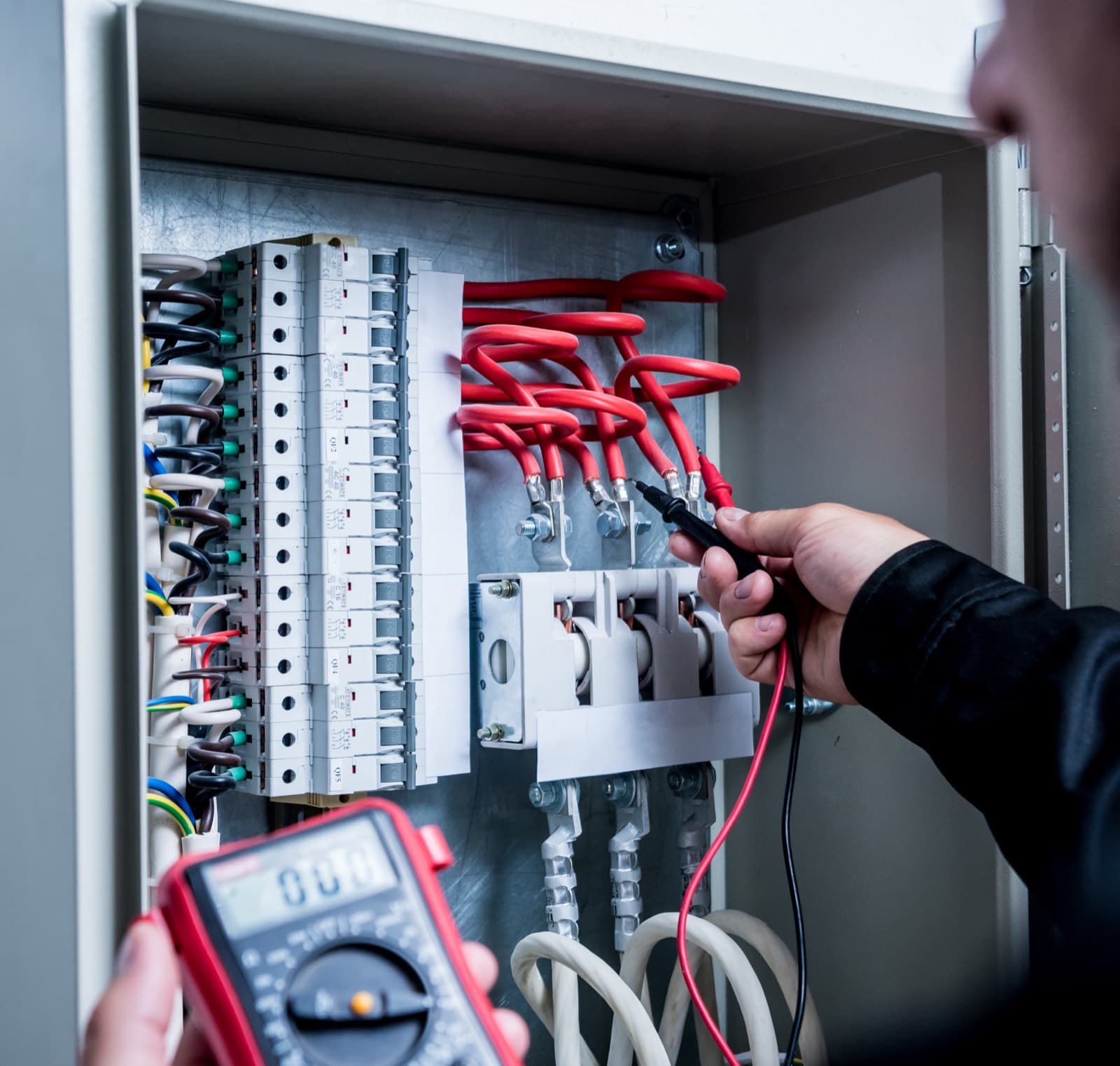 Electrician wiring a residential breaker panel